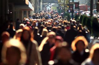 Massive anonymous crowd on an NYC sidewalk.