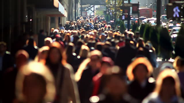 Massive anonymous crowd on an NYC sidewalk.