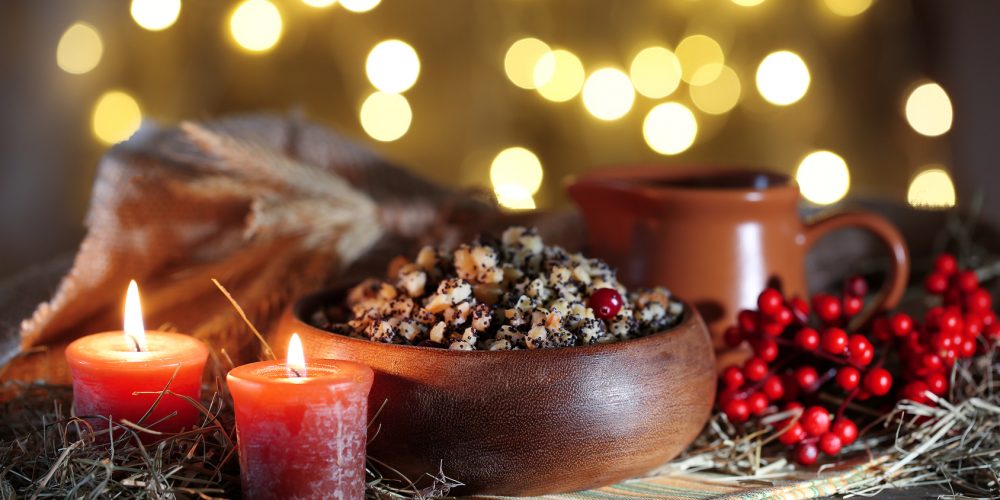 Bowl with kutia -  traditional Christmas sweet meal in Ukraine, Belarus and Poland, on wooden table, on bright background