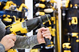Hammer drill in man's hands closeup
