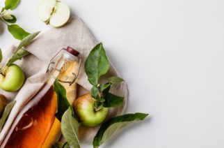 Apple cider vinegar and fresh apples, flat lay, space for your text. Fermented food concept